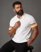 Man wearing a white polo shirt with striped sleeves against a gray background