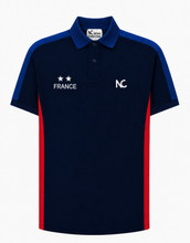 A navy blue short-sleeve polo shirt with royal blue shoulder panels and red side stripes, featuring white 'FRANCE' text with two stars on the right chest and a white 'NC' logo on the left chest, shown on a light gray background.